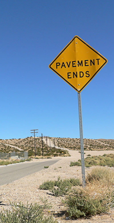 A sign says pavement ends