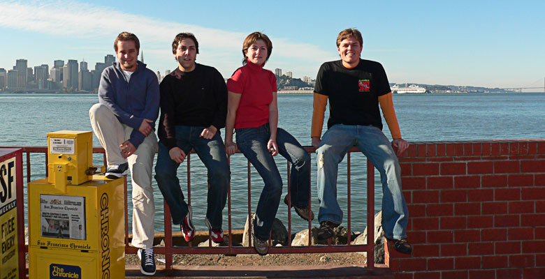 Four interns in front of the San Francisco skyline.