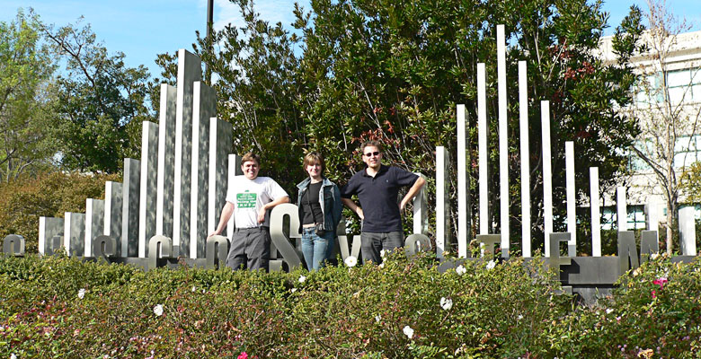 Daniel, Zhanna and Tim in front of the Cisco Systems logo