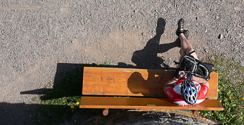 Mountain Biker resting on a Bench