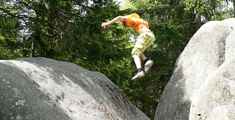 Daniel jumping from one rock to another.