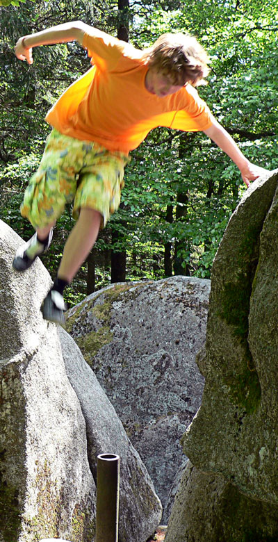 Daniel jumps off a rock