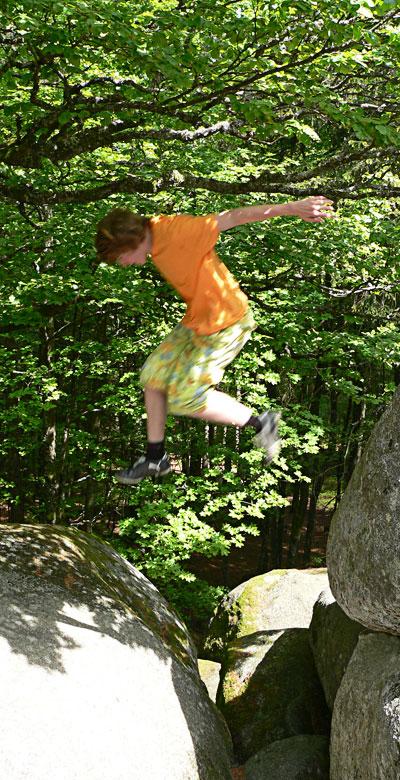 Daniel jumping from one rock to another.