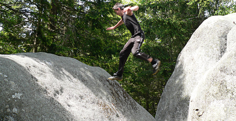 Florian jumping from one rock to another.