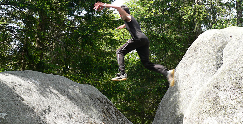 Florian jumping from one rock to another.